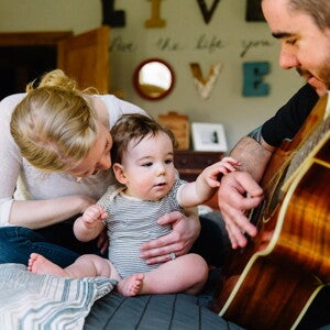 Baby listening to daddy play guitar