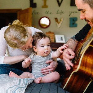 Baby listening to daddy play guitar